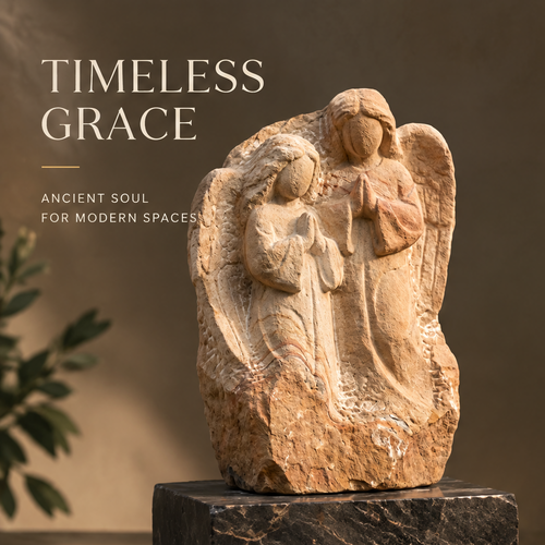 VITALUXO Raw Stone Angel Relief Sculpture front view on dark marble base with olive plant in warm interior light — Timeless Grace, Ancient Soul for Modern Spaces